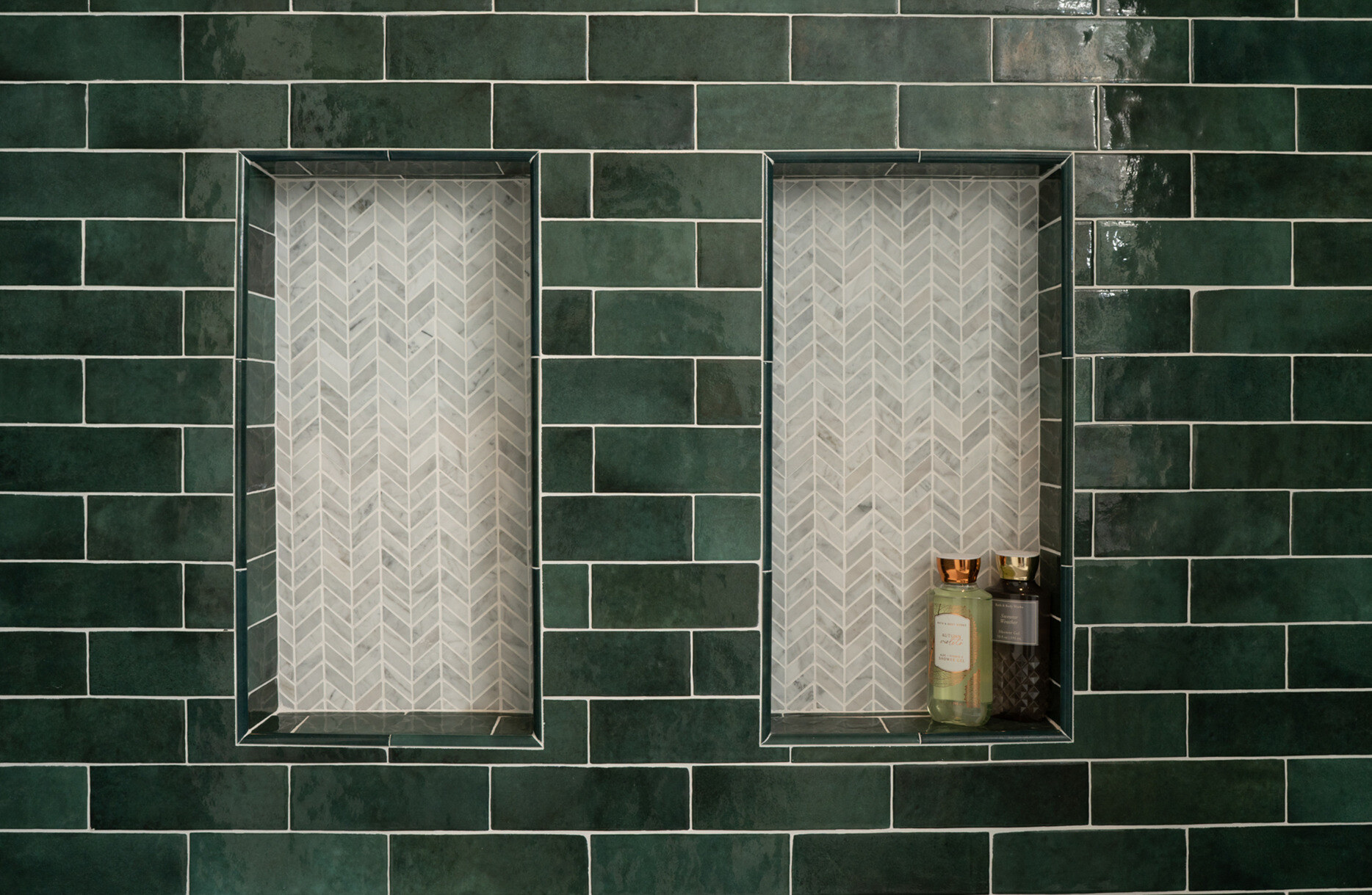 Inset shower shelf with accent chevron tiling in Fresno, CA bathroom remodel by Imagine Remodeling