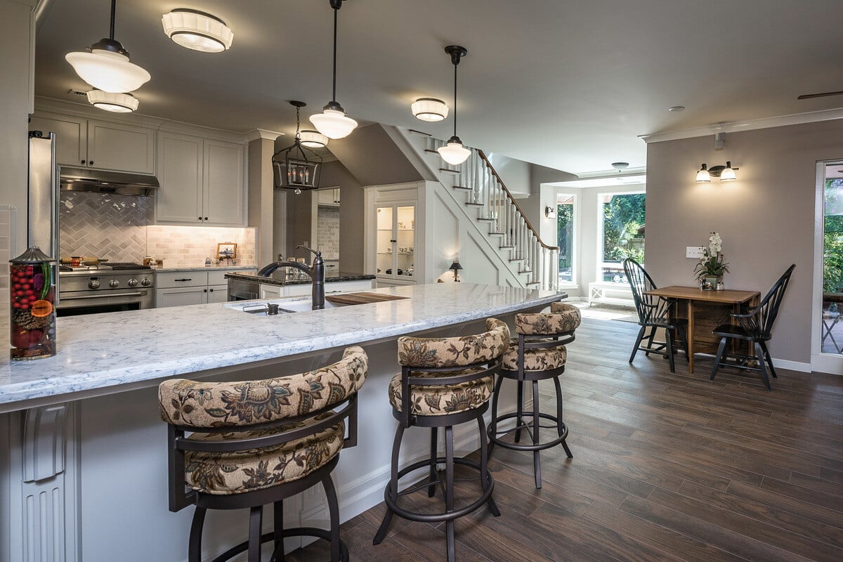 Island with seating and sink in Fresno, CA kitchen remodel with task lighting by Imagine Remodeling